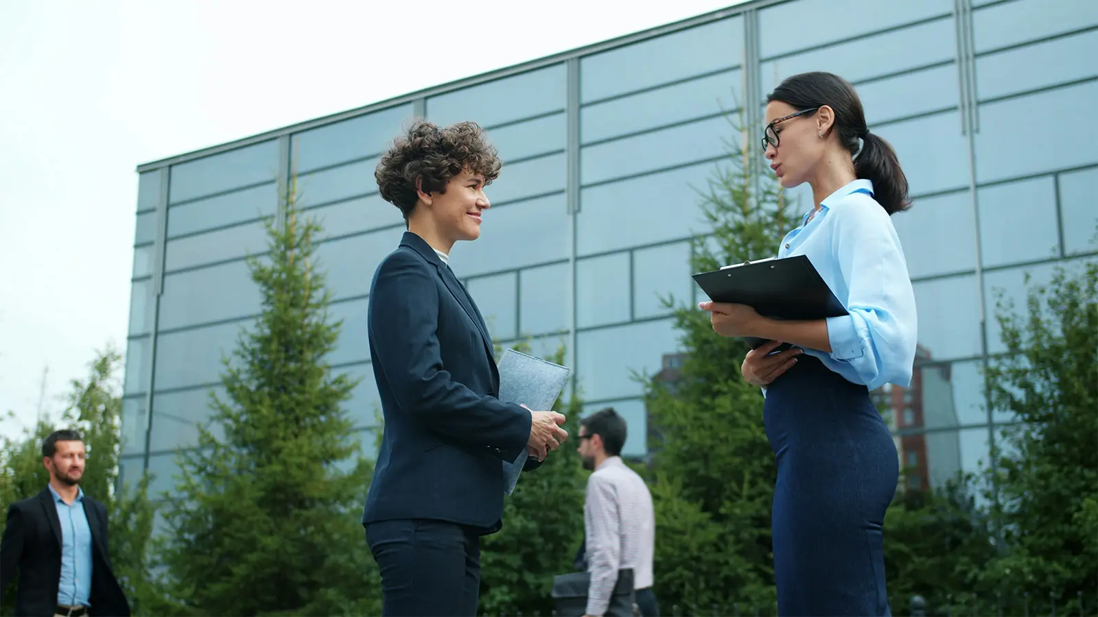 Two business colleagues meeting outside their office