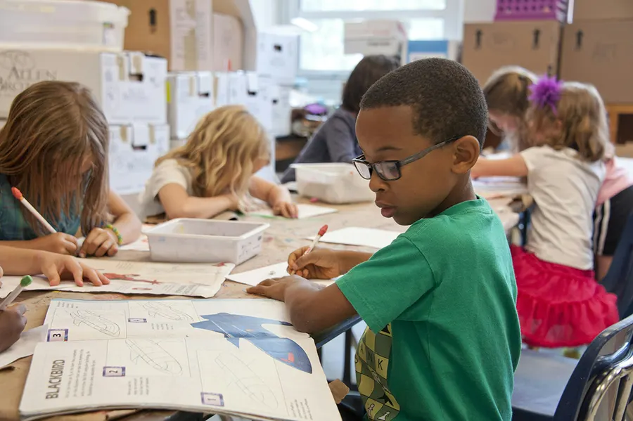 Children working on a printed activity sheet in class